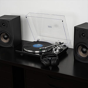 A Dayton Audio turntable alongside bookshelf speakers.