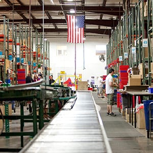 The Parts Express warehouse with warehouse employees picking items for orders.