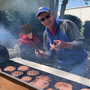 Grilling burgers at a team cookout event.