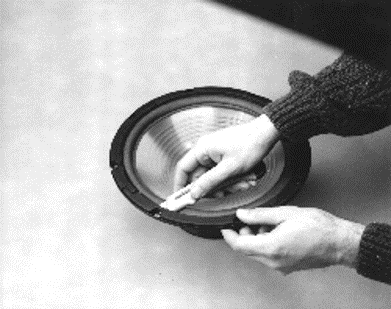 Removing the gasket material from the speaker.