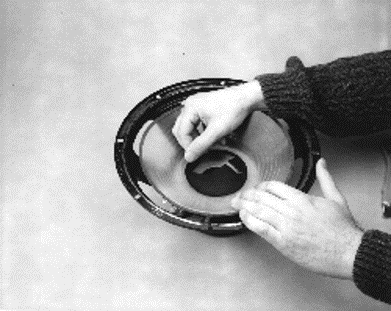 Carefully removing the dust cap.